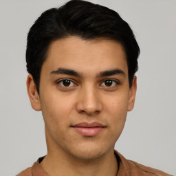 Joyful latino young-adult male with short  brown hair and brown eyes