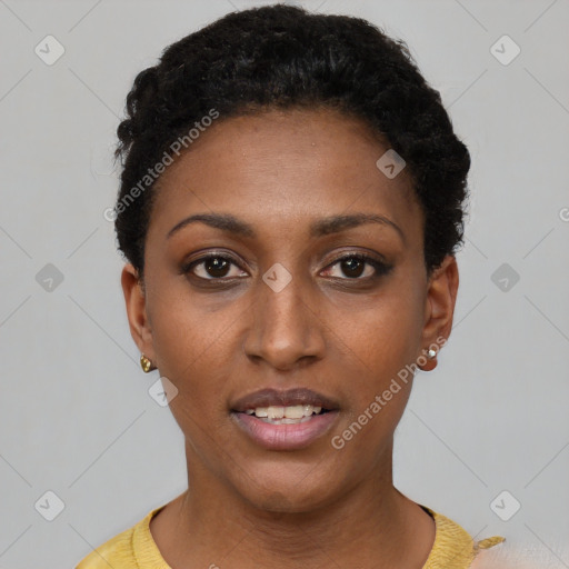 Joyful black young-adult female with short  black hair and brown eyes