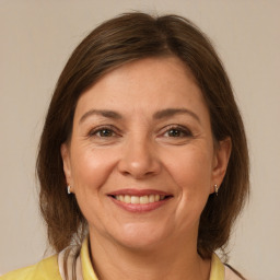 Joyful white adult female with medium  brown hair and brown eyes