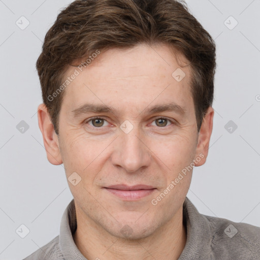 Joyful white adult male with short  brown hair and grey eyes