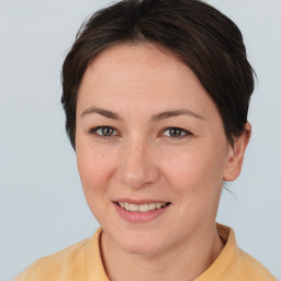 Joyful white adult female with medium  brown hair and brown eyes