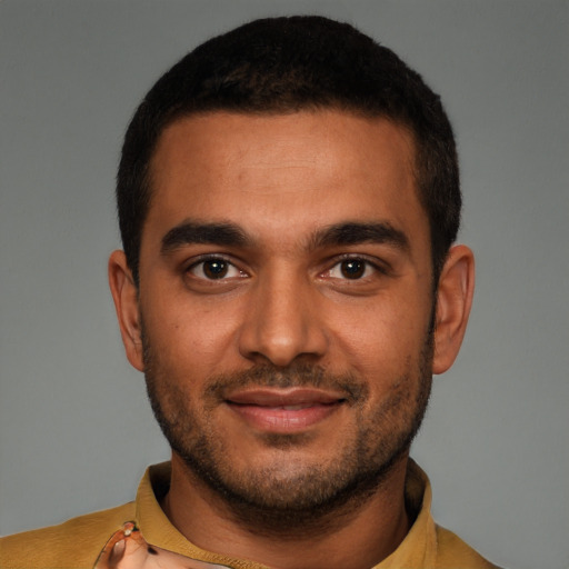 Joyful latino young-adult male with short  brown hair and brown eyes