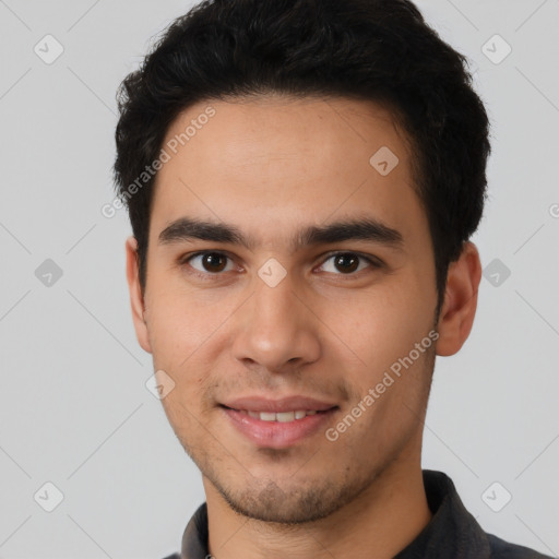 Joyful white young-adult male with short  black hair and brown eyes