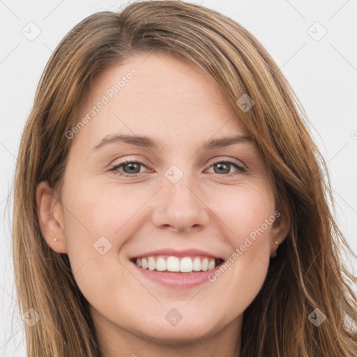 Joyful white young-adult female with long  brown hair and green eyes