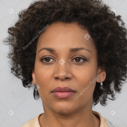 Joyful black adult female with medium  brown hair and brown eyes