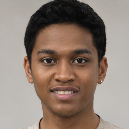 Joyful black young-adult male with short  black hair and brown eyes