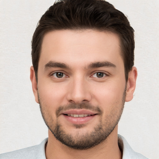 Joyful white young-adult male with short  brown hair and brown eyes