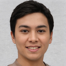 Joyful asian young-adult male with short  black hair and brown eyes