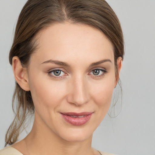 Joyful white young-adult female with medium  brown hair and grey eyes