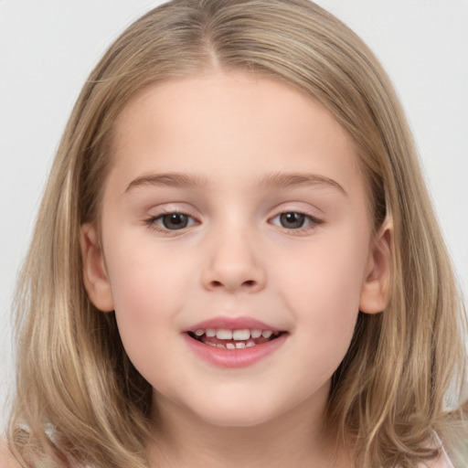 Joyful white child female with medium  brown hair and brown eyes