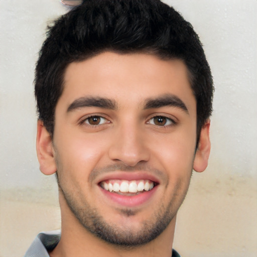 Joyful latino young-adult male with short  black hair and brown eyes