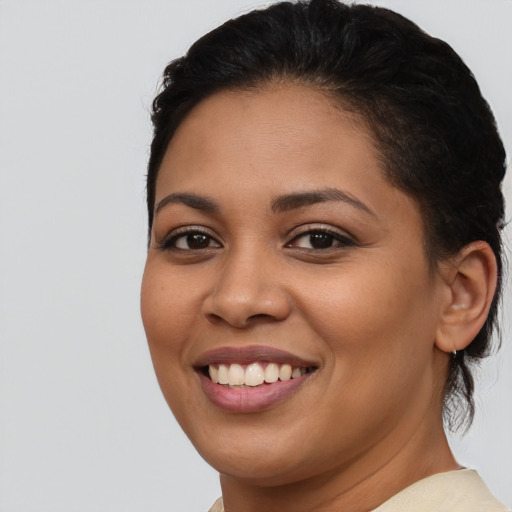 Joyful latino young-adult female with short  brown hair and brown eyes