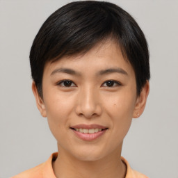 Joyful asian young-adult female with short  brown hair and brown eyes