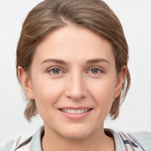 Joyful white young-adult female with medium  brown hair and grey eyes