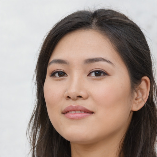 Joyful asian young-adult female with long  brown hair and brown eyes