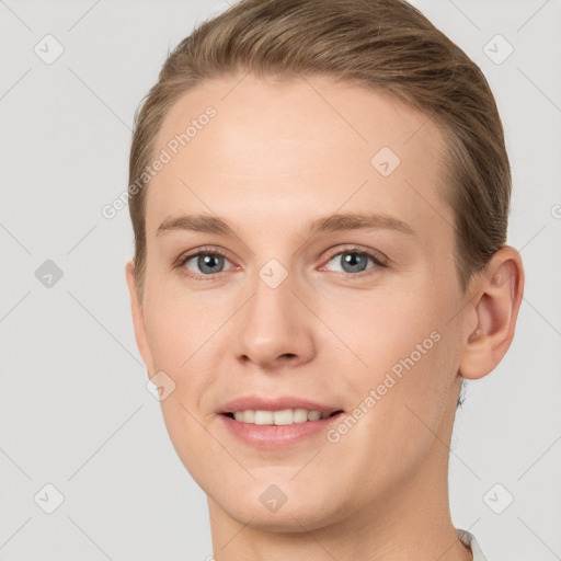 Joyful white young-adult female with short  brown hair and grey eyes