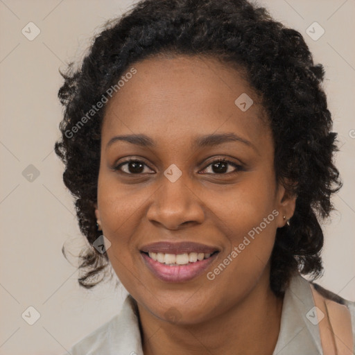 Joyful black young-adult female with long  black hair and brown eyes