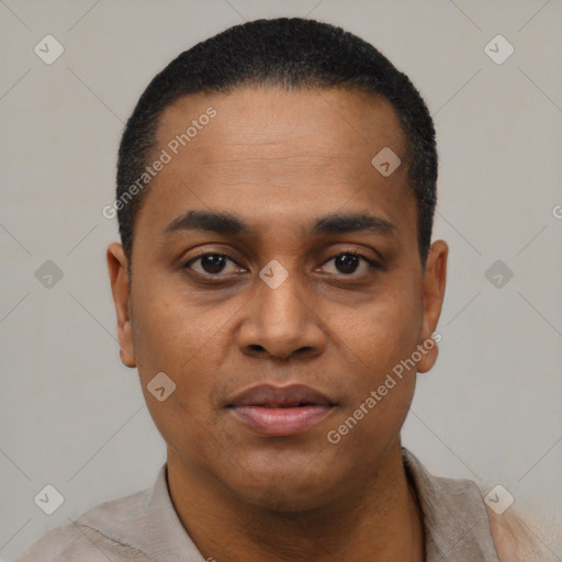 Joyful black young-adult male with short  black hair and brown eyes