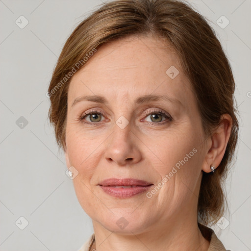 Joyful white adult female with medium  brown hair and grey eyes