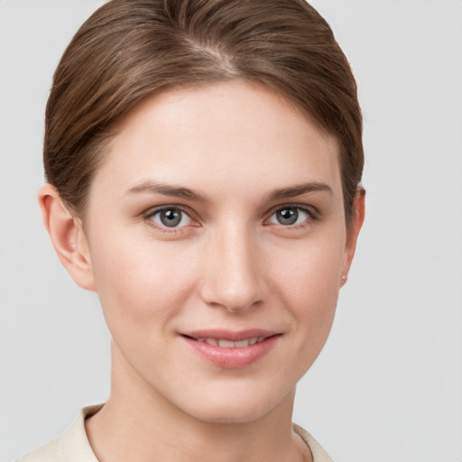 Joyful white young-adult female with short  brown hair and grey eyes