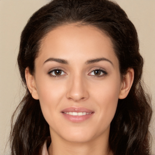 Joyful white young-adult female with long  brown hair and brown eyes