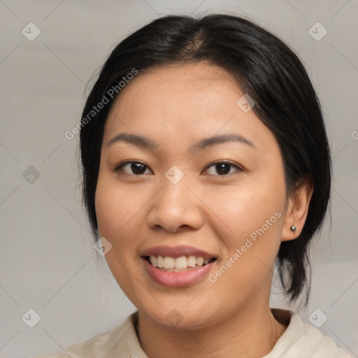 Joyful asian young-adult female with medium  black hair and brown eyes