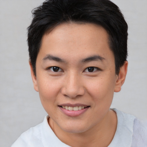 Joyful white young-adult male with short  brown hair and brown eyes