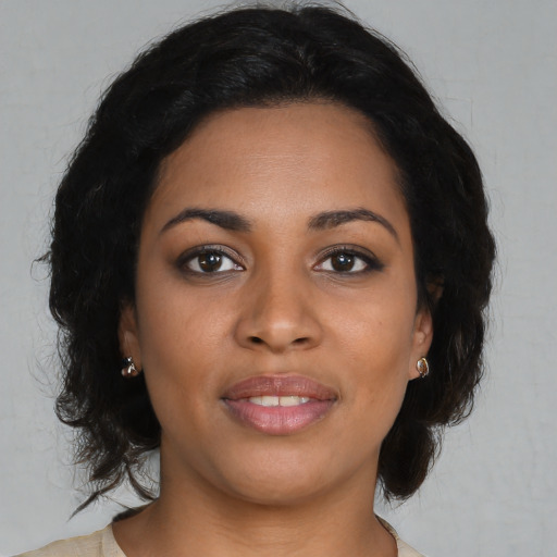 Joyful black young-adult female with medium  brown hair and brown eyes