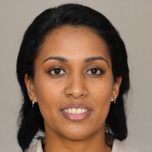 Joyful black young-adult female with medium  black hair and brown eyes