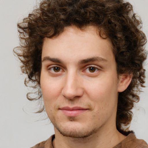 Joyful white young-adult male with medium  brown hair and brown eyes