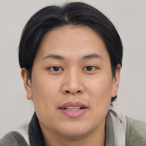 Joyful asian young-adult male with short  brown hair and brown eyes