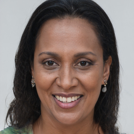Joyful black adult female with long  brown hair and brown eyes