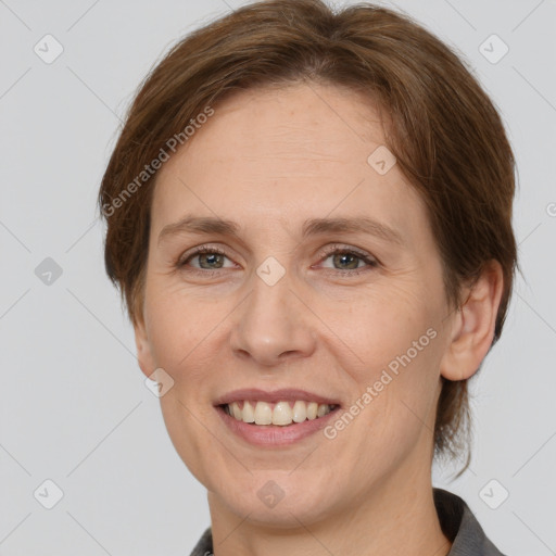 Joyful white adult female with medium  brown hair and grey eyes