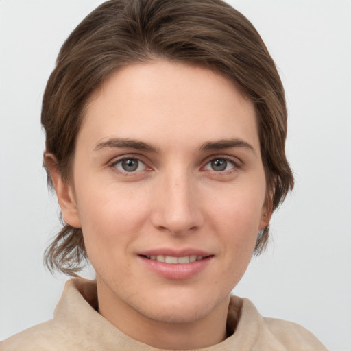 Joyful white young-adult female with short  brown hair and grey eyes