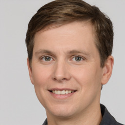 Joyful white adult male with short  brown hair and grey eyes