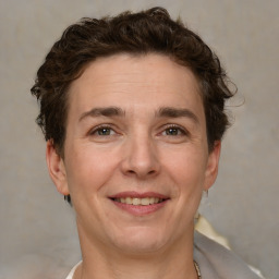 Joyful white adult female with short  brown hair and brown eyes