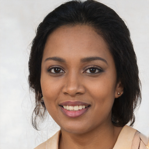 Joyful black young-adult female with medium  brown hair and brown eyes