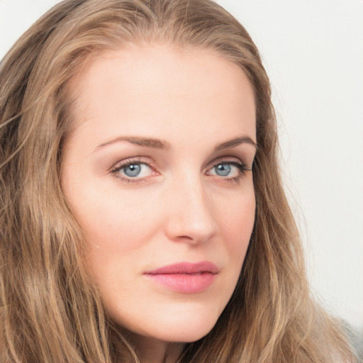 Joyful white young-adult female with long  brown hair and blue eyes