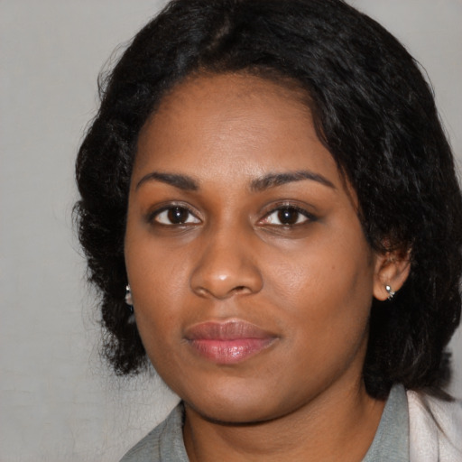 Joyful black young-adult female with medium  black hair and brown eyes
