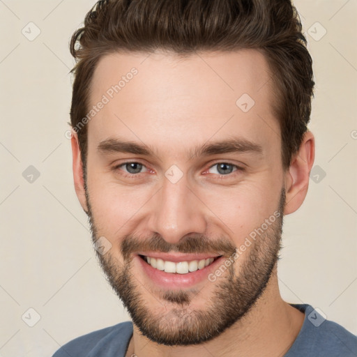 Joyful white young-adult male with short  brown hair and brown eyes