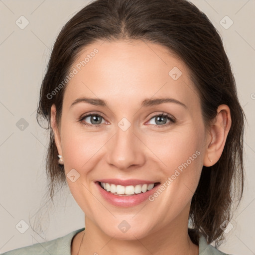 Joyful white young-adult female with medium  brown hair and grey eyes