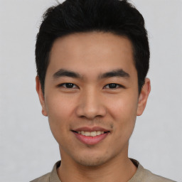 Joyful asian young-adult male with short  black hair and brown eyes