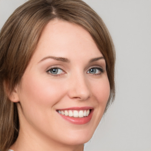 Joyful white young-adult female with medium  brown hair and green eyes