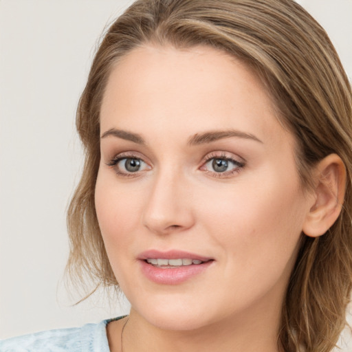 Joyful white young-adult female with medium  brown hair and blue eyes