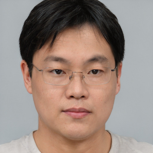 Neutral asian adult male with short  brown hair and brown eyes
