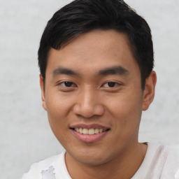 Joyful asian young-adult male with short  black hair and brown eyes