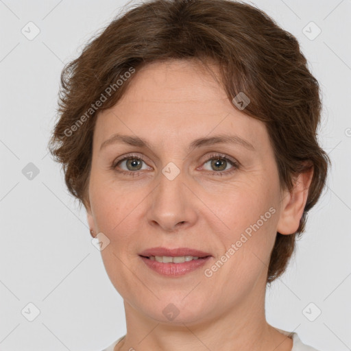 Joyful white adult female with short  brown hair and grey eyes