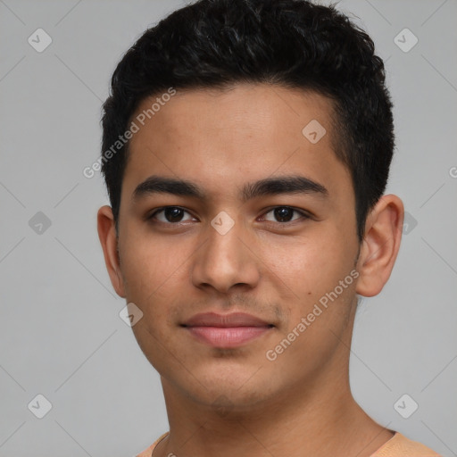 Joyful latino young-adult male with short  black hair and brown eyes