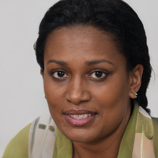 Joyful black young-adult female with short  brown hair and brown eyes