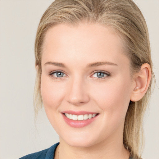 Joyful white young-adult female with medium  brown hair and blue eyes